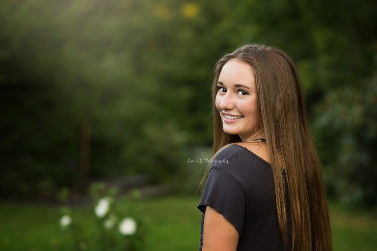 Senior girl smiling at Dow Gardens. Midland, Michigan photographer