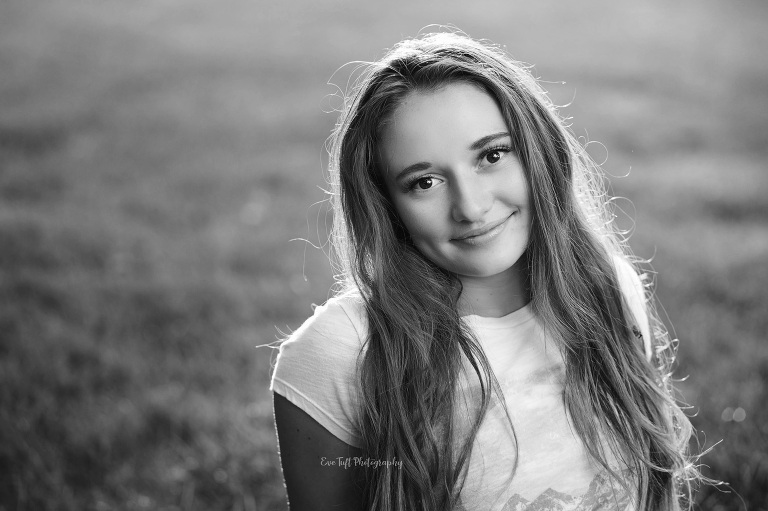 Senior girl in black and white smiling at the camera. Midland, Michigan photographer