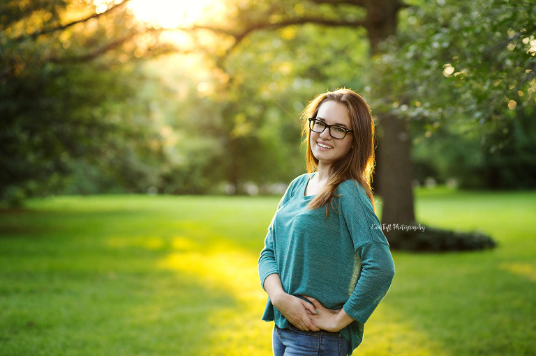 Senior girl smiling at the camera with hands on her hip. Midland, Michigan photographer