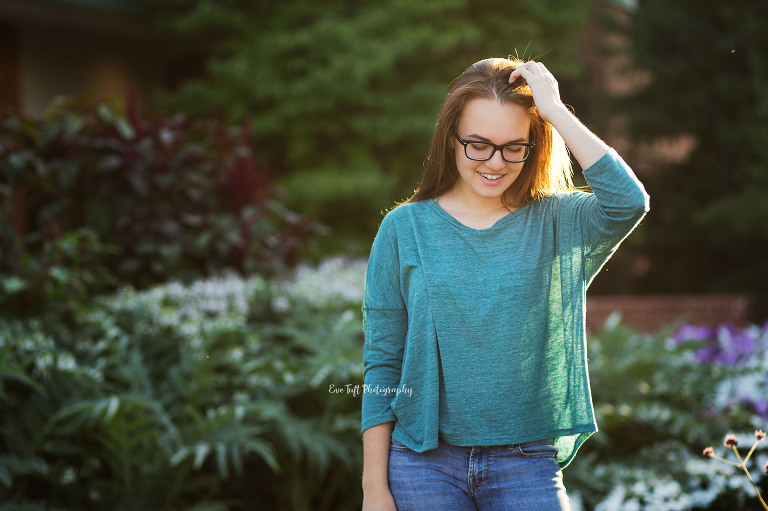 Senior girl touching hair and looking down. Midland, Michigan photographer