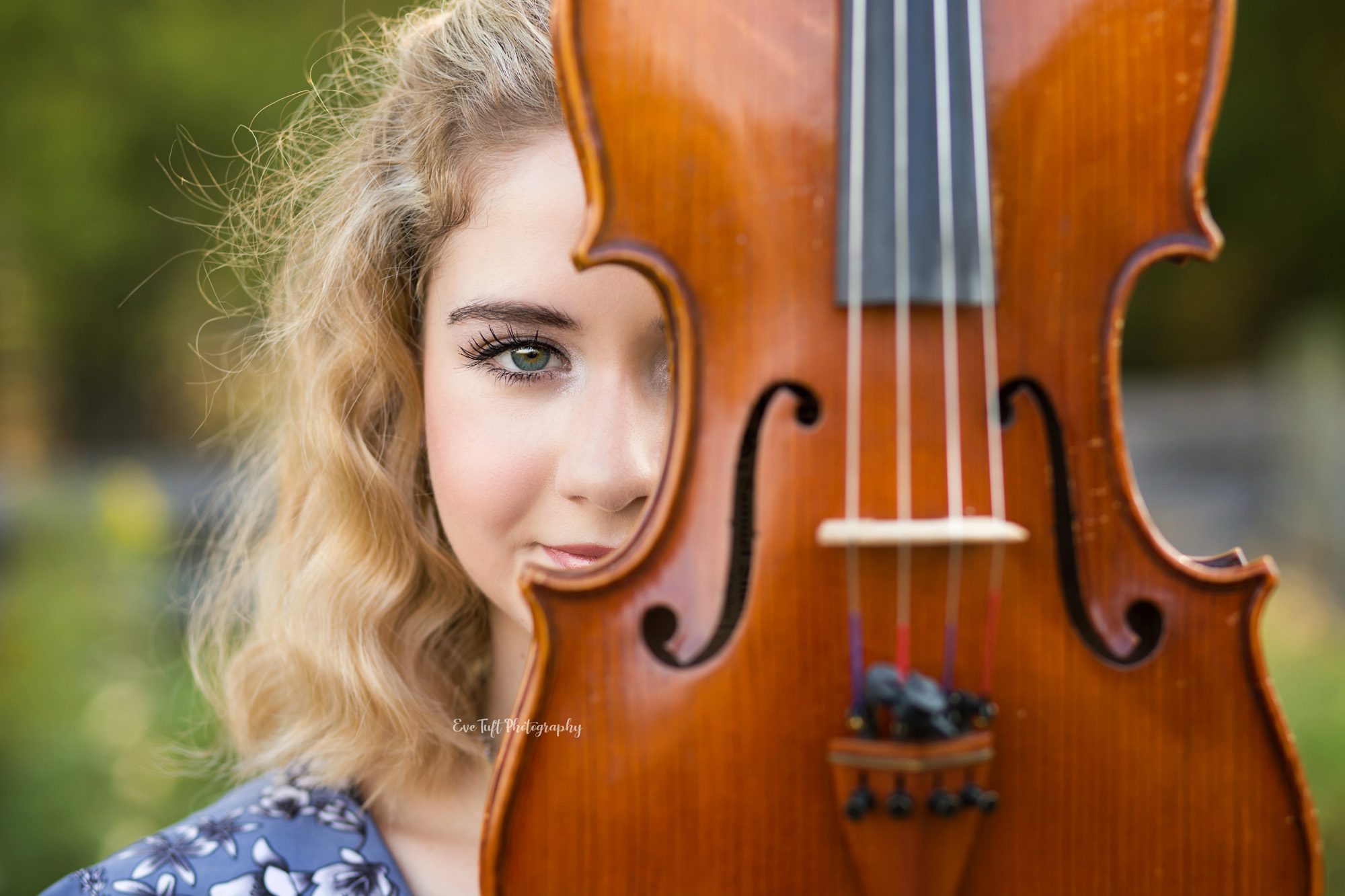 Senior girl holding viola up by her face. Midland, Michigan photographer