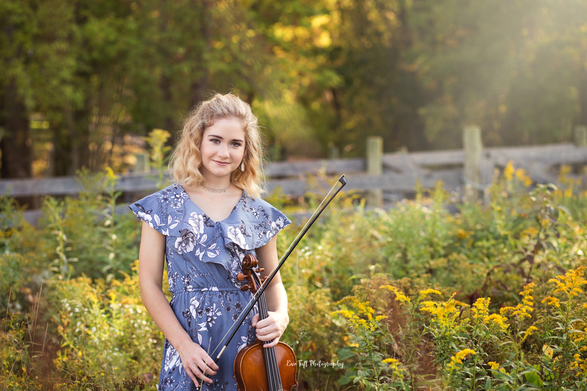 Senior girl standing in a field holding her viola. Midland, Michigan Photographer. Musical instrument.