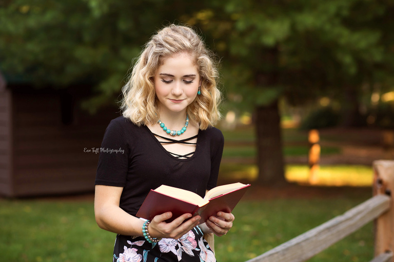 Senior girl reading a book in Dow Gardens. Midland, Michigan photographer