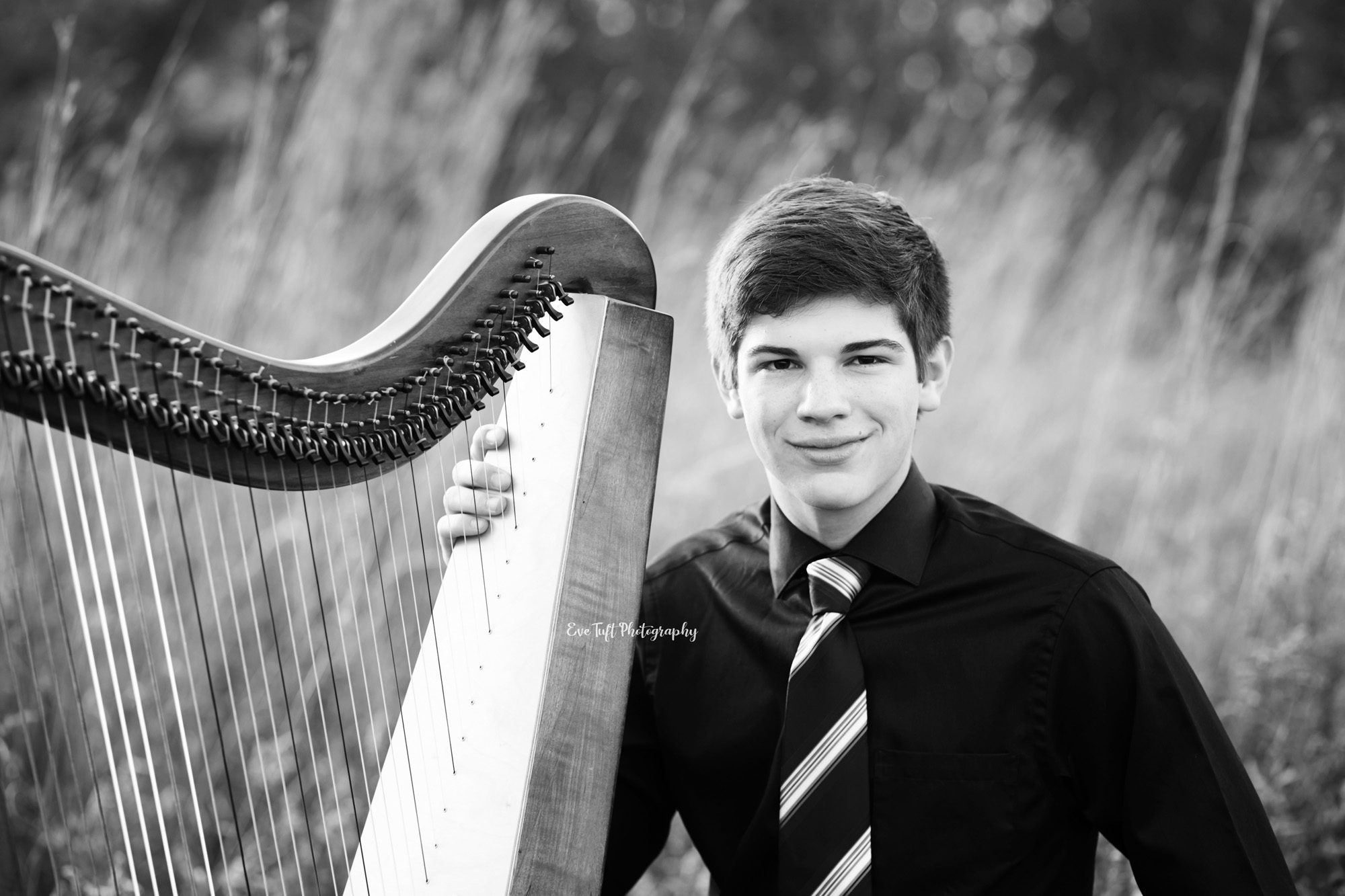 Senior boy sitting next to his harp at the Chippewa Nature Center. Midland, Michigan photography