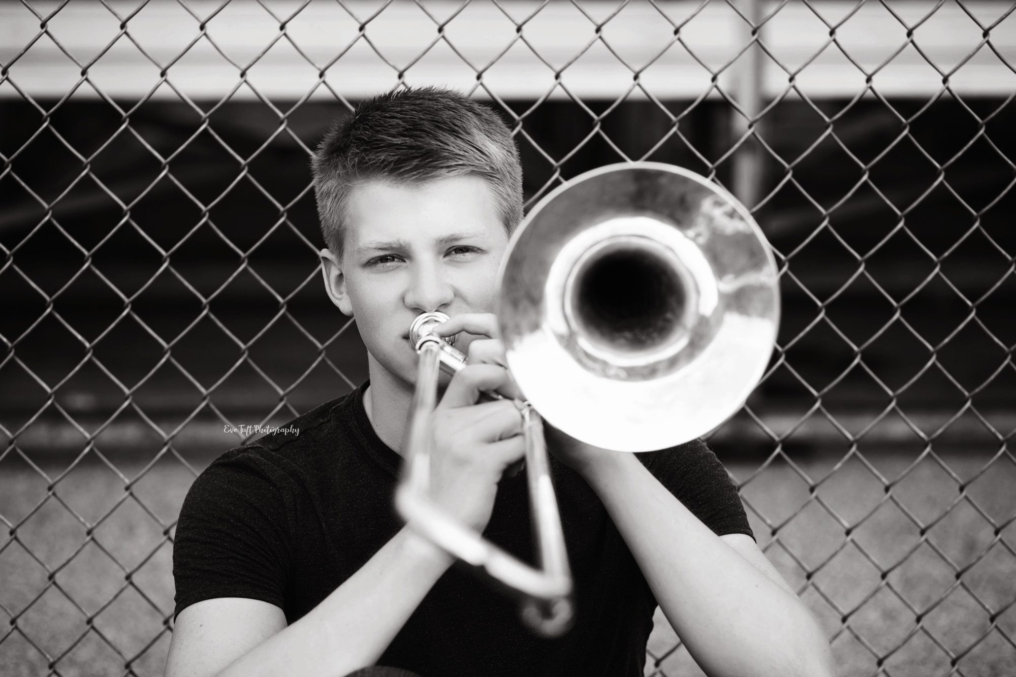 Senior boy playing his trombone in black and white. Midland, Michigan photographer