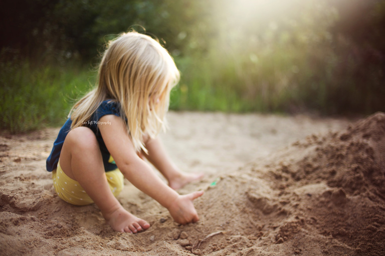 Girl digging in the sand. Midland, Michigan photographer