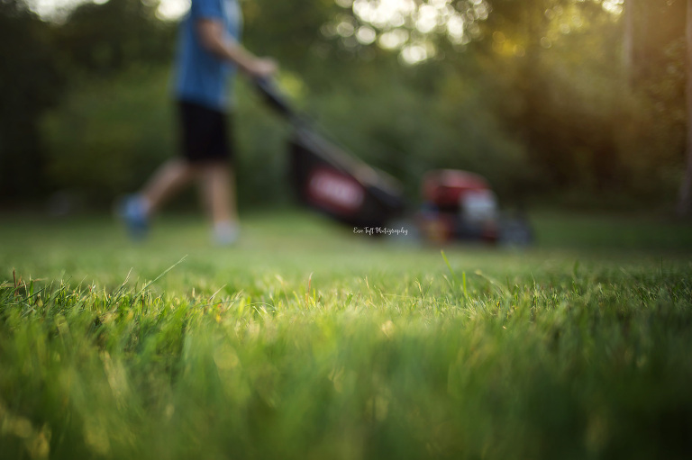 Man mowing lawn in summer time. Midland, Michigan photographer