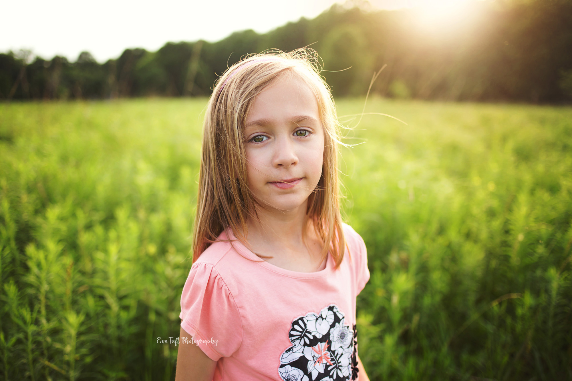 Portrait of a girl looking at the camera outside in a field. Midland, Michigan photographer