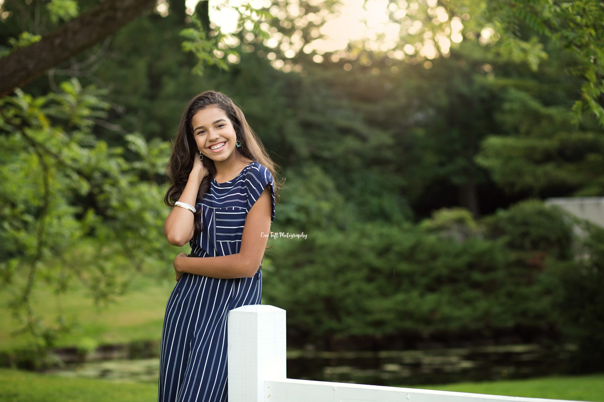 Tall Brazil senior laughing by a fence. Midland, Michigan Photography