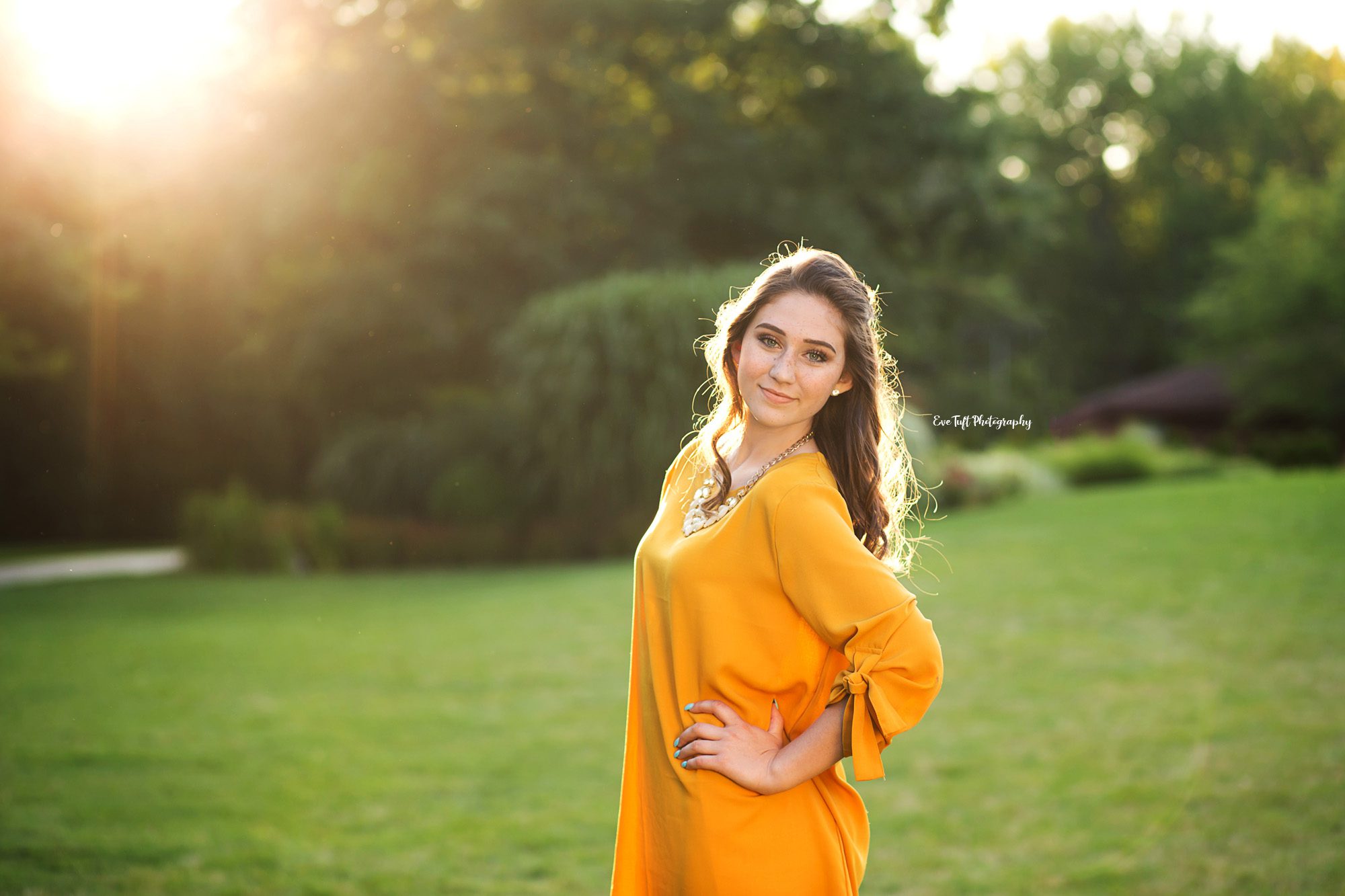 Senior girl in a field on a sunny day with her hand on her hip | High School Senior Photographer in Midland, Michigan