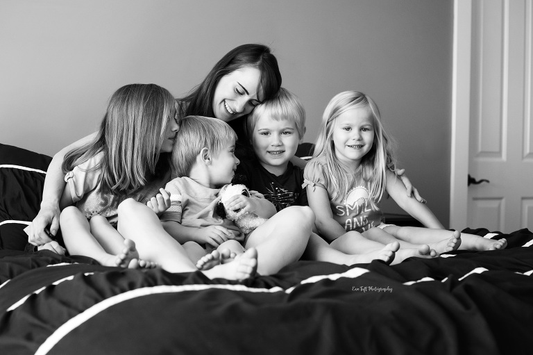 A mother and four of her children on the bed snuggling and loving each other | Saginaw Photos