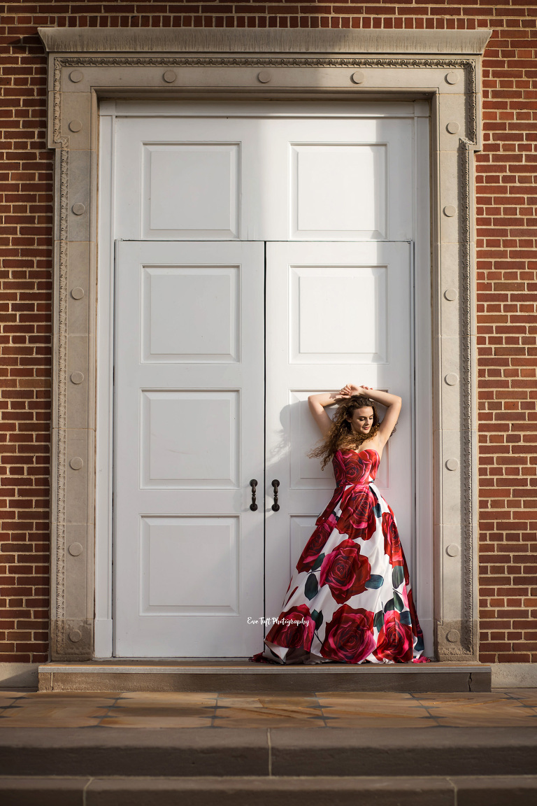 Contrasted light on a senior girl who's standing in front of white doors outside of a church | Midland, MI photography