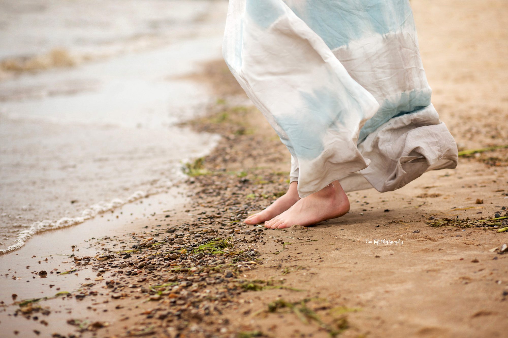 Girl in a dress standing on the beach on a windy day | Bay City Photographer
