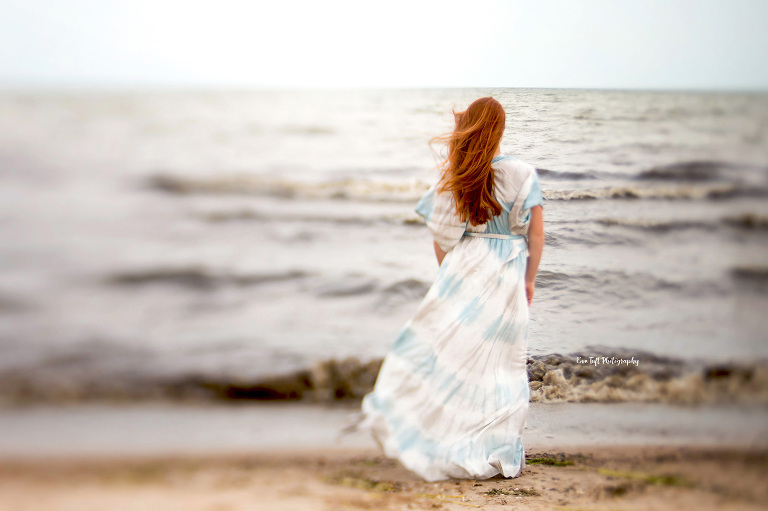 Teenage girl with long, red hair on the beach in Bay City, Michigan | Senior Portraits