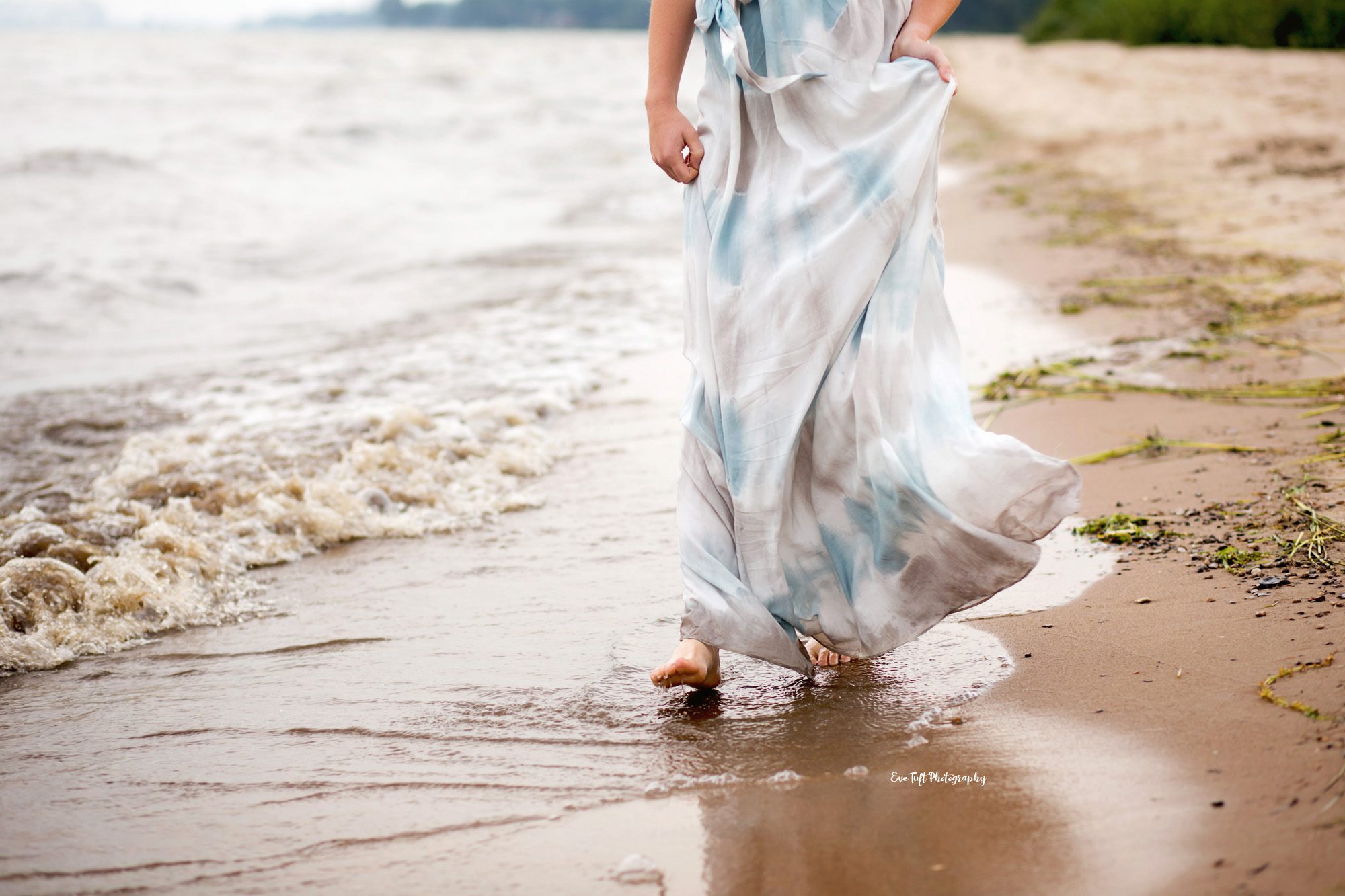 Girl in a dress walking on the beach on a windy day | Bay City Photographer