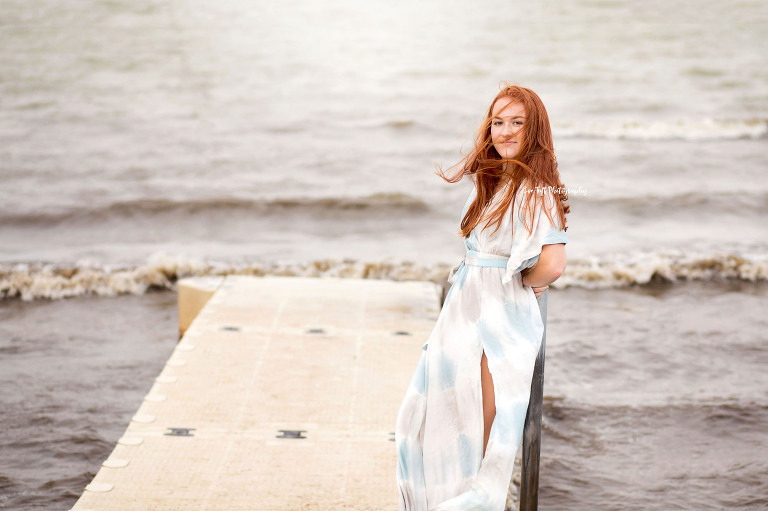 Teenage girl with long, red hair on the beach in Bay City, Michigan | Senior Portraits