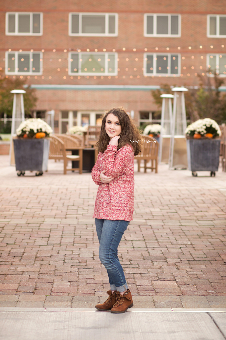 Teenage girl standing and posing in front of a big building | Bay City Senior Photographer