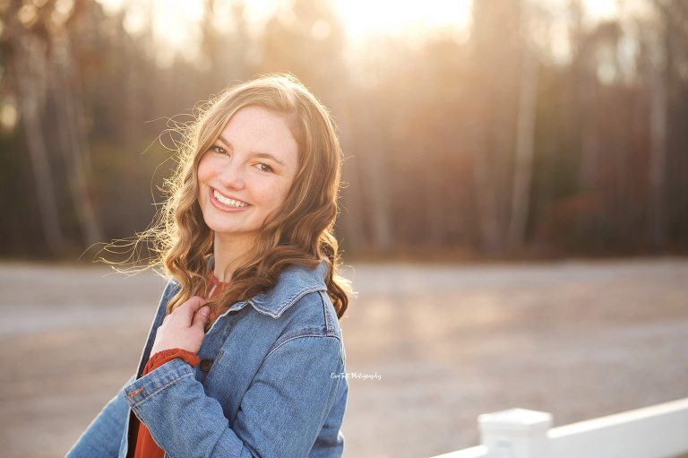 Senior girl posing with her hand on her jean jacket | MidMichigan high school photographer