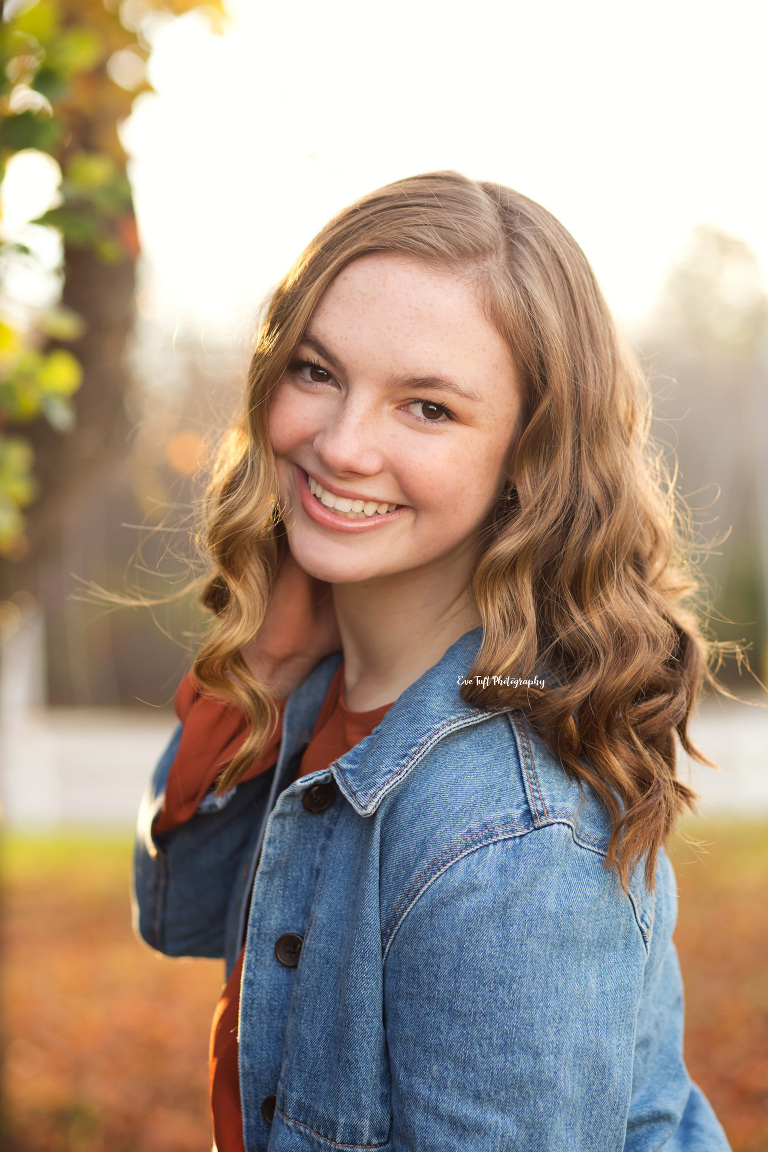 Senior girl leaning into the camera while touching her hair | Saginaw and Auburn photographer for teens and high school portraits