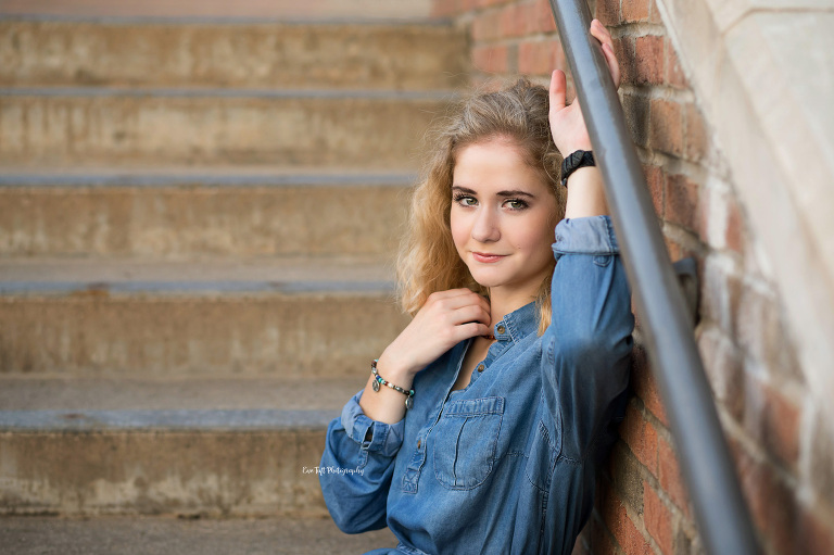 A senior girl sitting on stairs downtown in Midland, Michigan | Senior Photographer