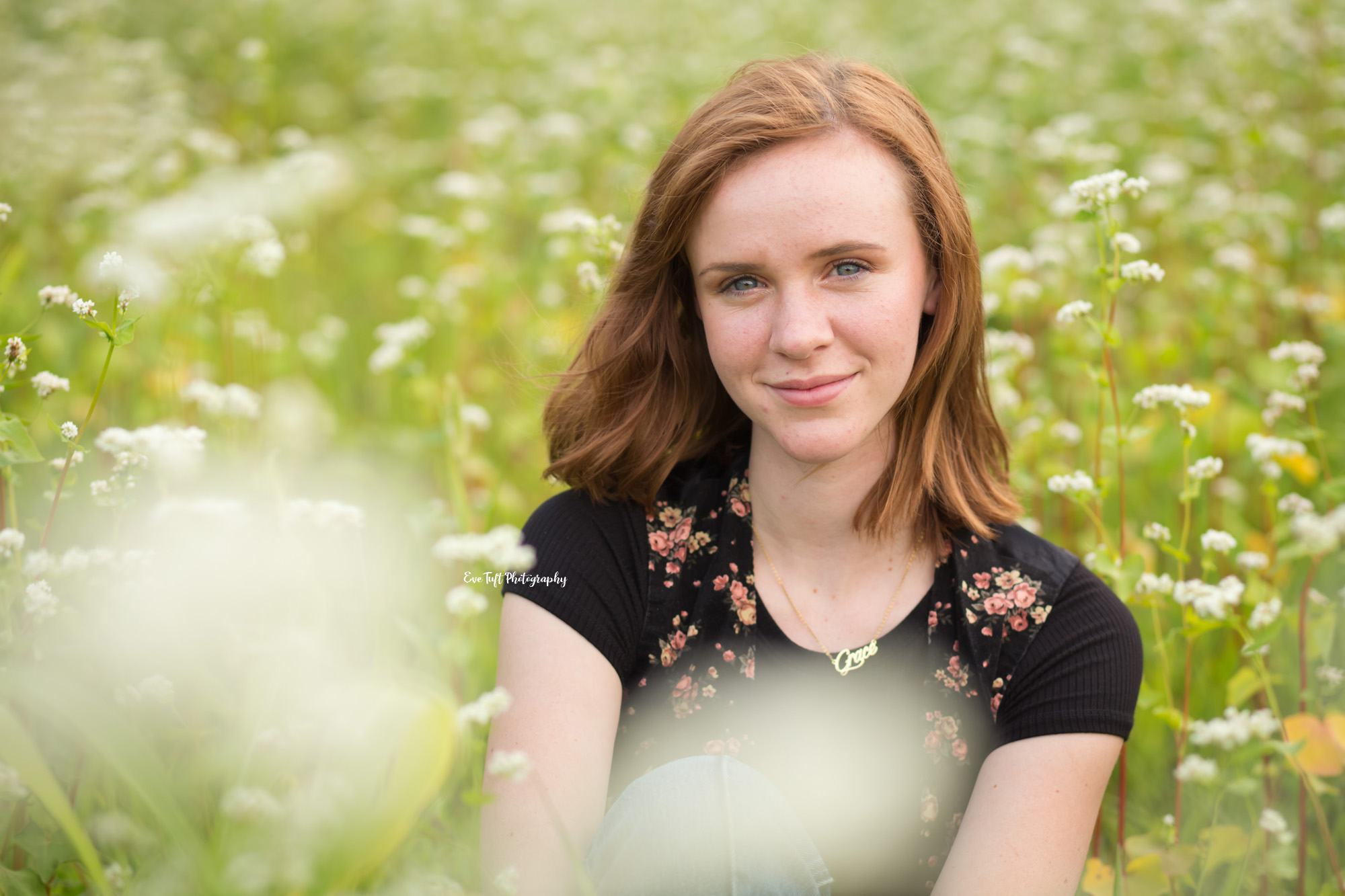Girl sitting in a field of wildflowers in Michigan | Senior portrait photographer 