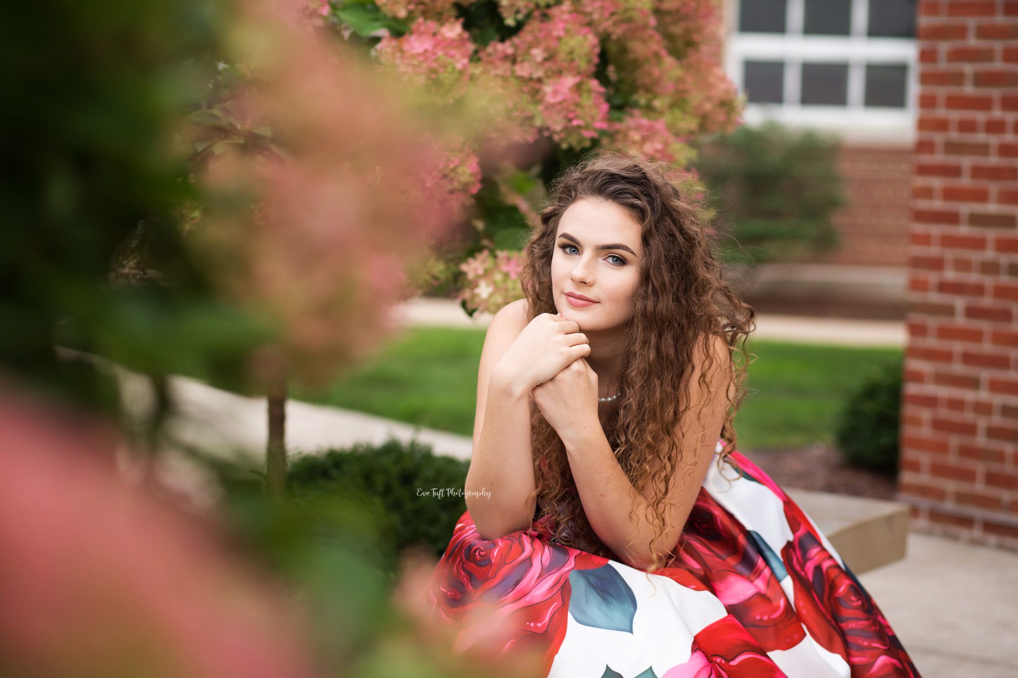 Senior girl in a prom dress surrounded by flowers and the benefits of a cloudy day | Senior Photographer in Saginaw, Michigan