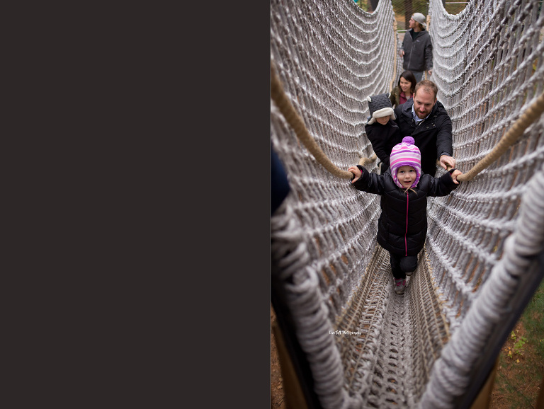 Small girl with hat on a rope pathway at a bucket list location | Michigan senior photographer