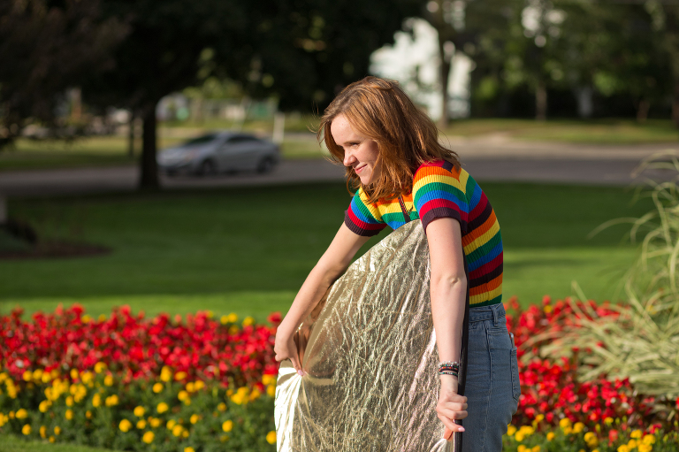 Senior girl holding a reflector for her friend