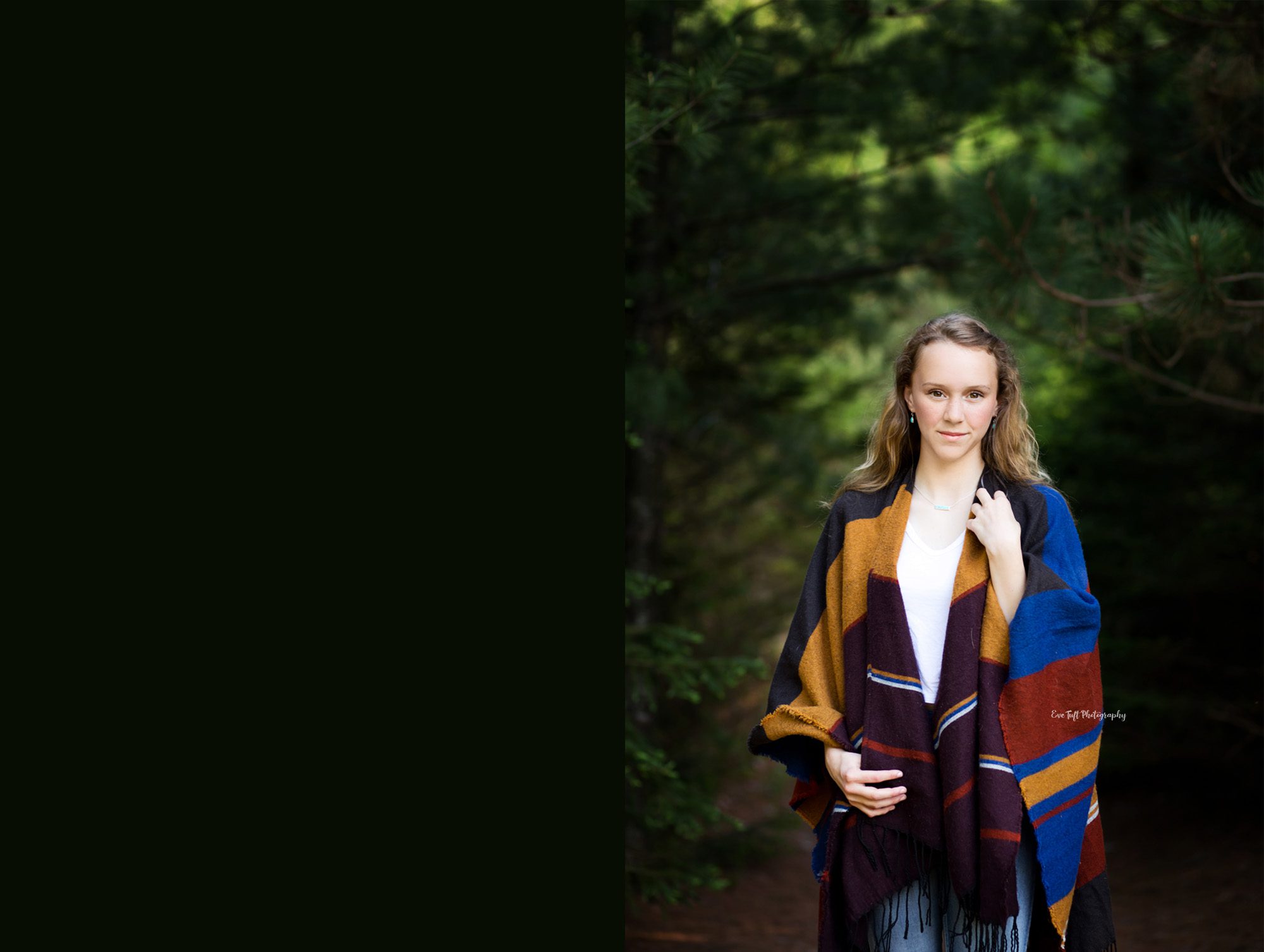 Senior girl facing the camera with her hands on her outfit