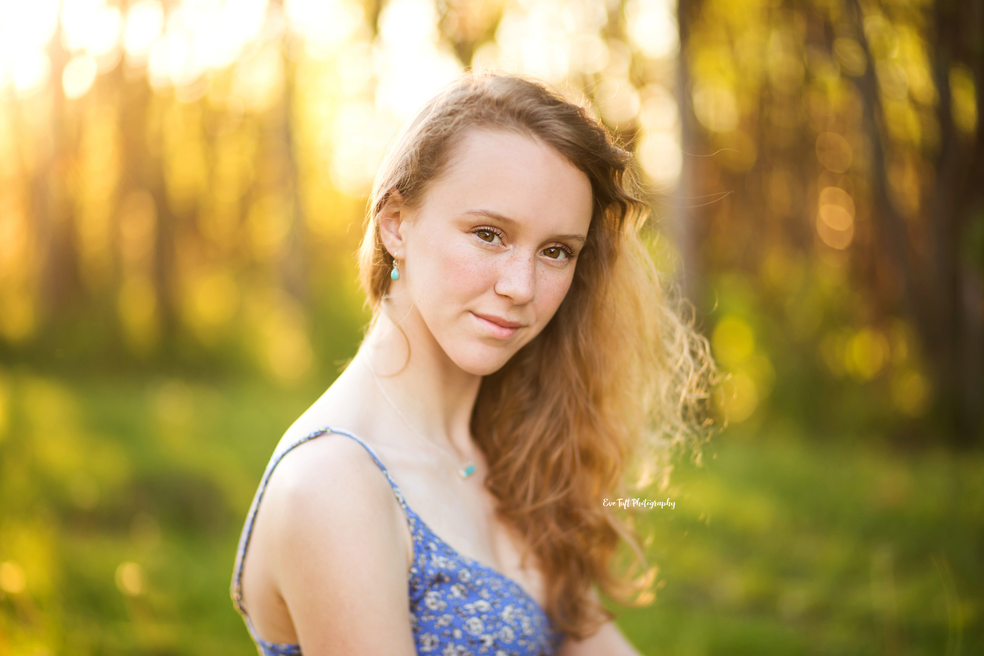 Freelensed image of a senior girl outside by some trees in an apple orchard | Portrait Photographer in Midland, Michigan