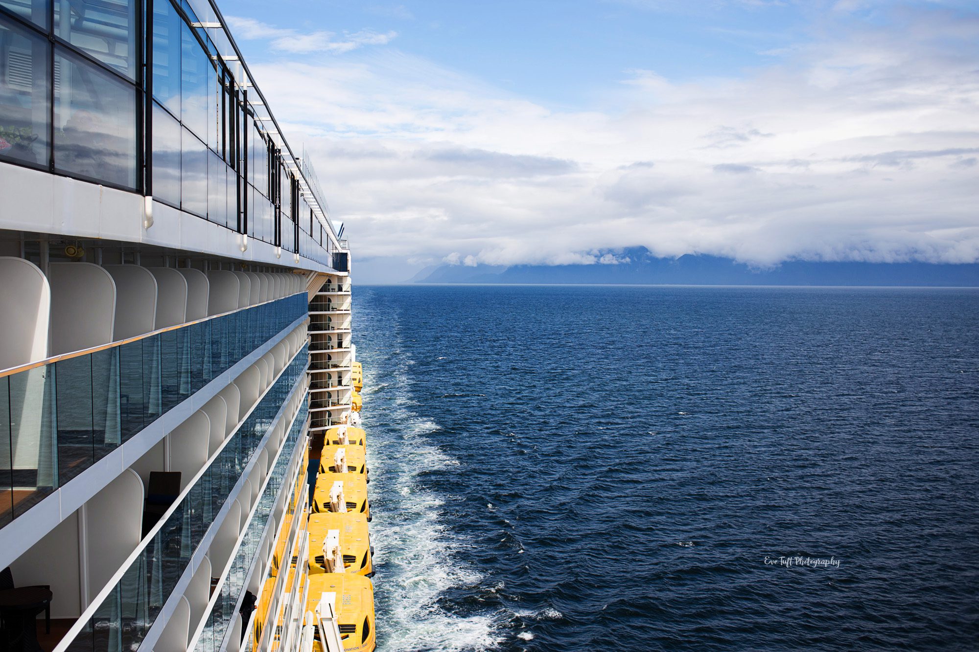 The side of a cruise ship sailing on the ocean