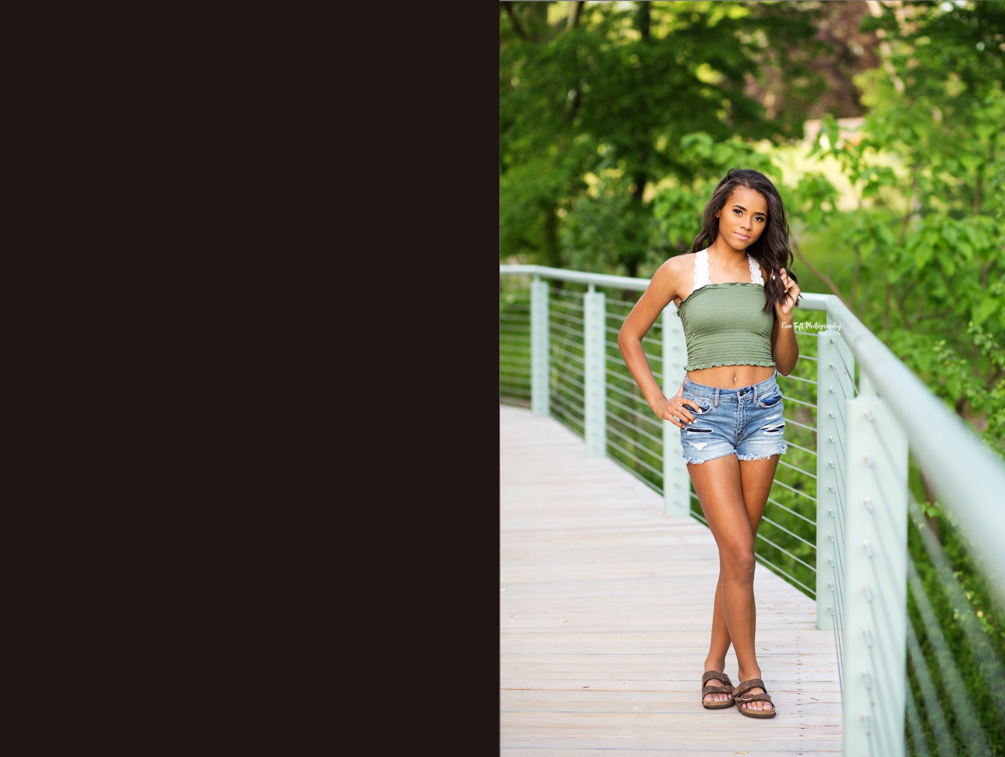 Senior girl standing with her hands on her hips and her legs crossed on a bridge | Michigan Photographer specializing with teens and seniors