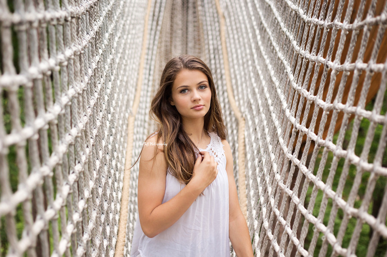 Chloe, a high school student, on a rope bridge at Whiting Forest in Midland | Michigan Senior Photographer