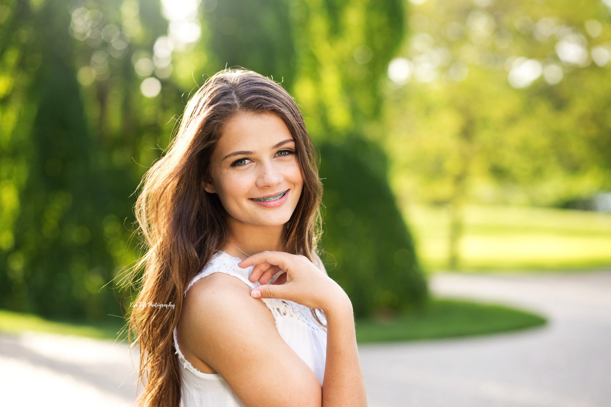 Senior girl posing with her arm on her shoulder outside | Senior Photographer in Midland, Michigan