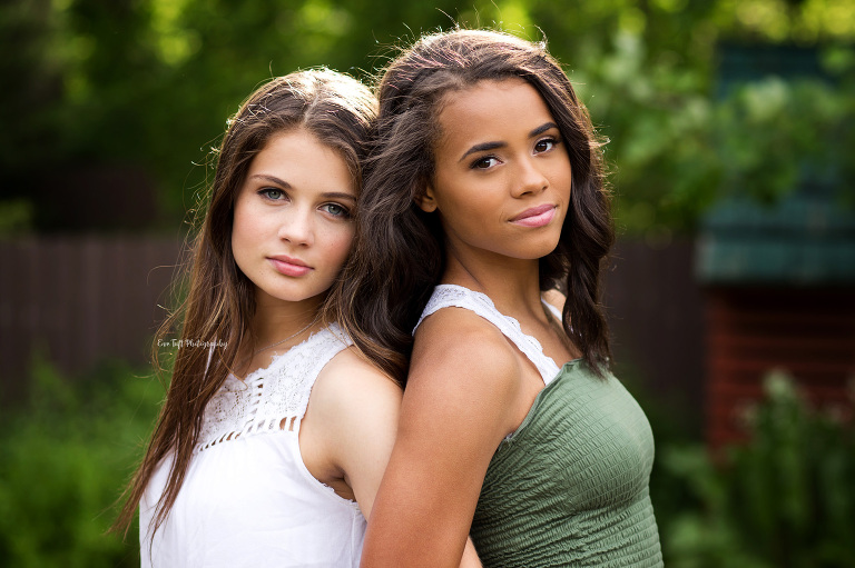 Best friends session | Two senior girls standing back to back outside | Senior Photographer in Midland, MI
