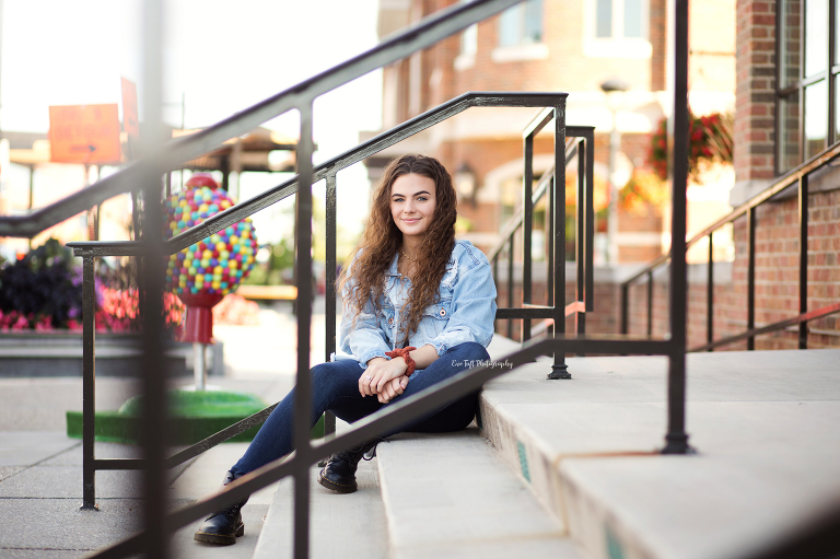 Senior girl sitting on the stairs for her urban photo shoot in Downtown Midland | Michigan Senior Photographer