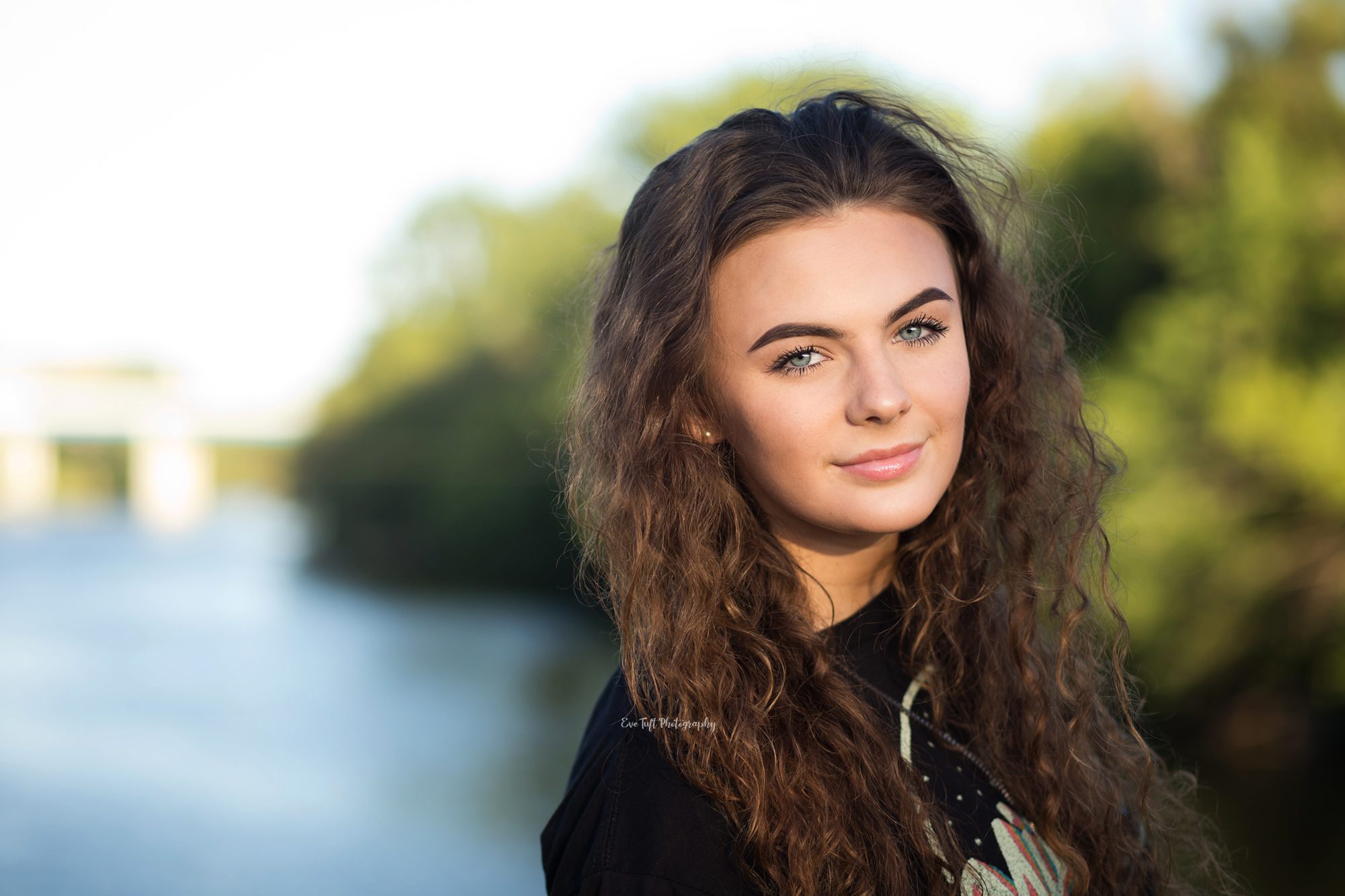 Close up of a high school girl with water behind her | Senior Photographer in Midland, MI