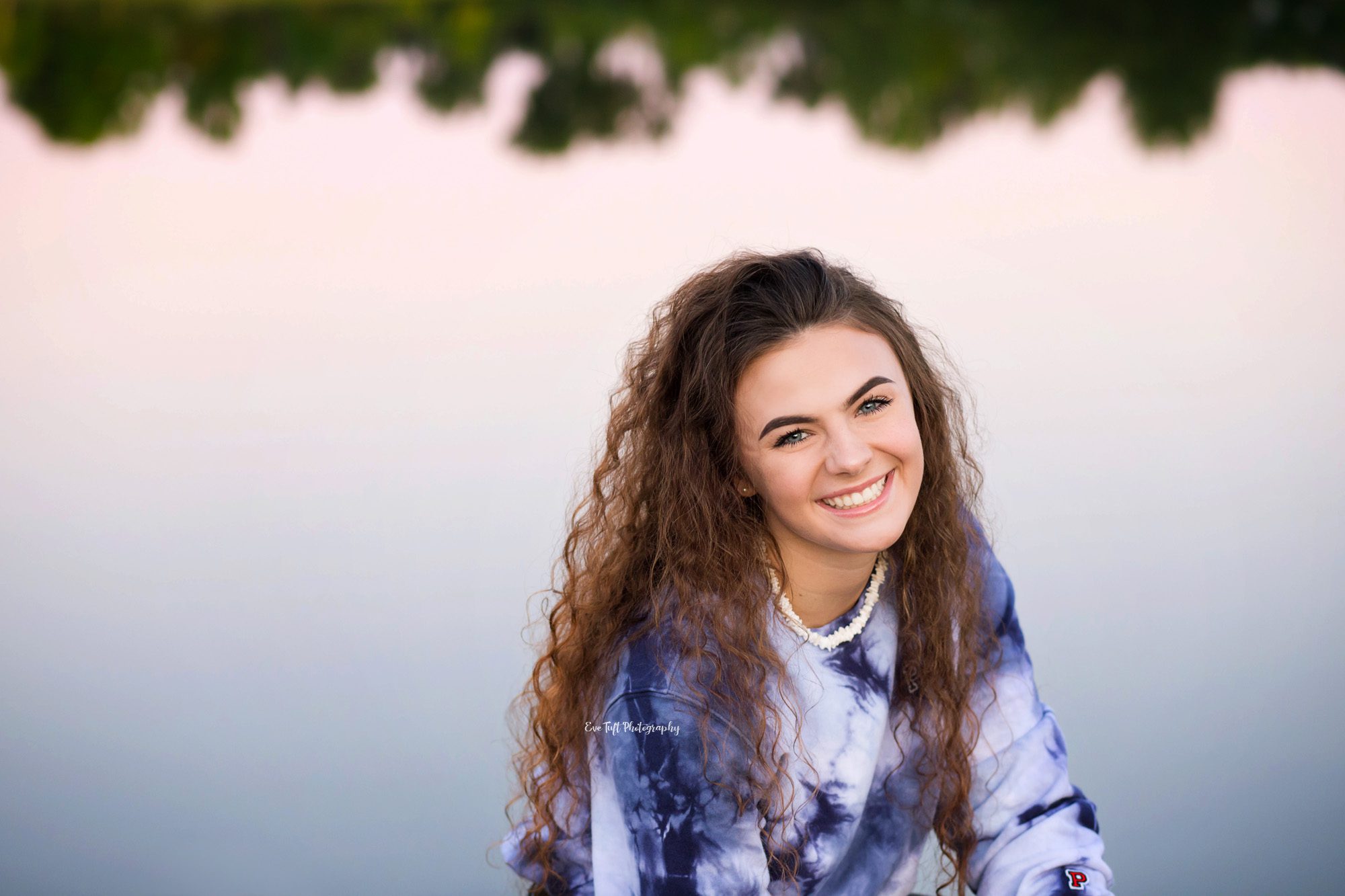 Senior girl smiling at the camera in front of a lake | Midland, Saginaw and Bay City Senior Photographer