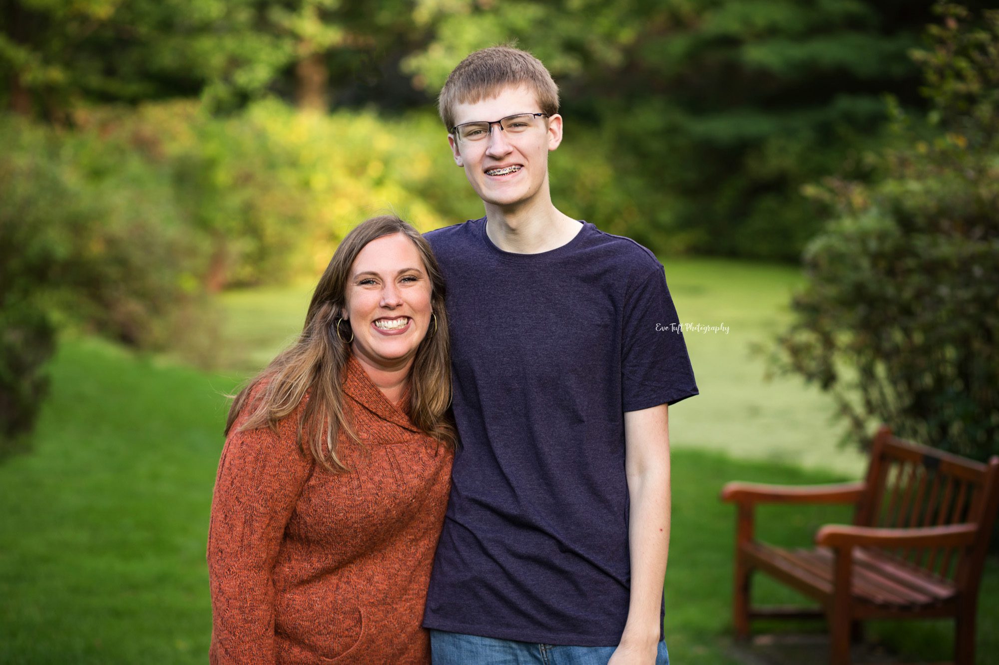 A senior boy and his mom with their arms around each other outside | Michigan Senior Photographer in Midland