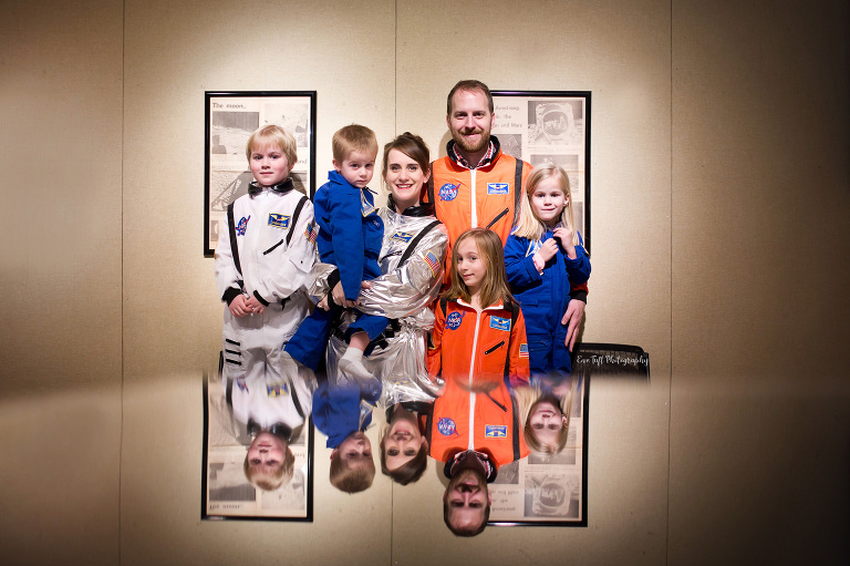 A family of six dress up in astronaut suits together at the Midland Center for the Arts in Midland