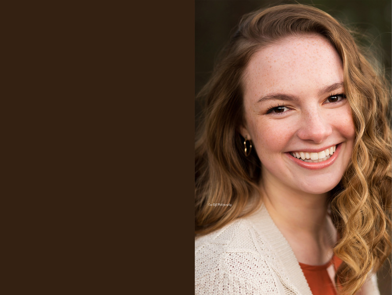 A beautiful senior girl smiles for her senior portraits while Eve Tuft lists cons in bringing props to a photo shoot | Michigan Senior Photographer