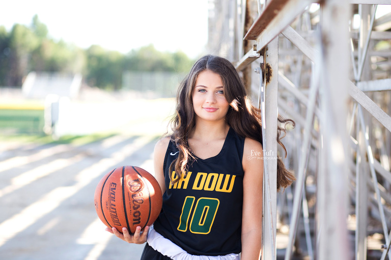 A senior girl takes sports shots at H. H. Dow High School for her senior session | Midland, Michigan Senior Photographer