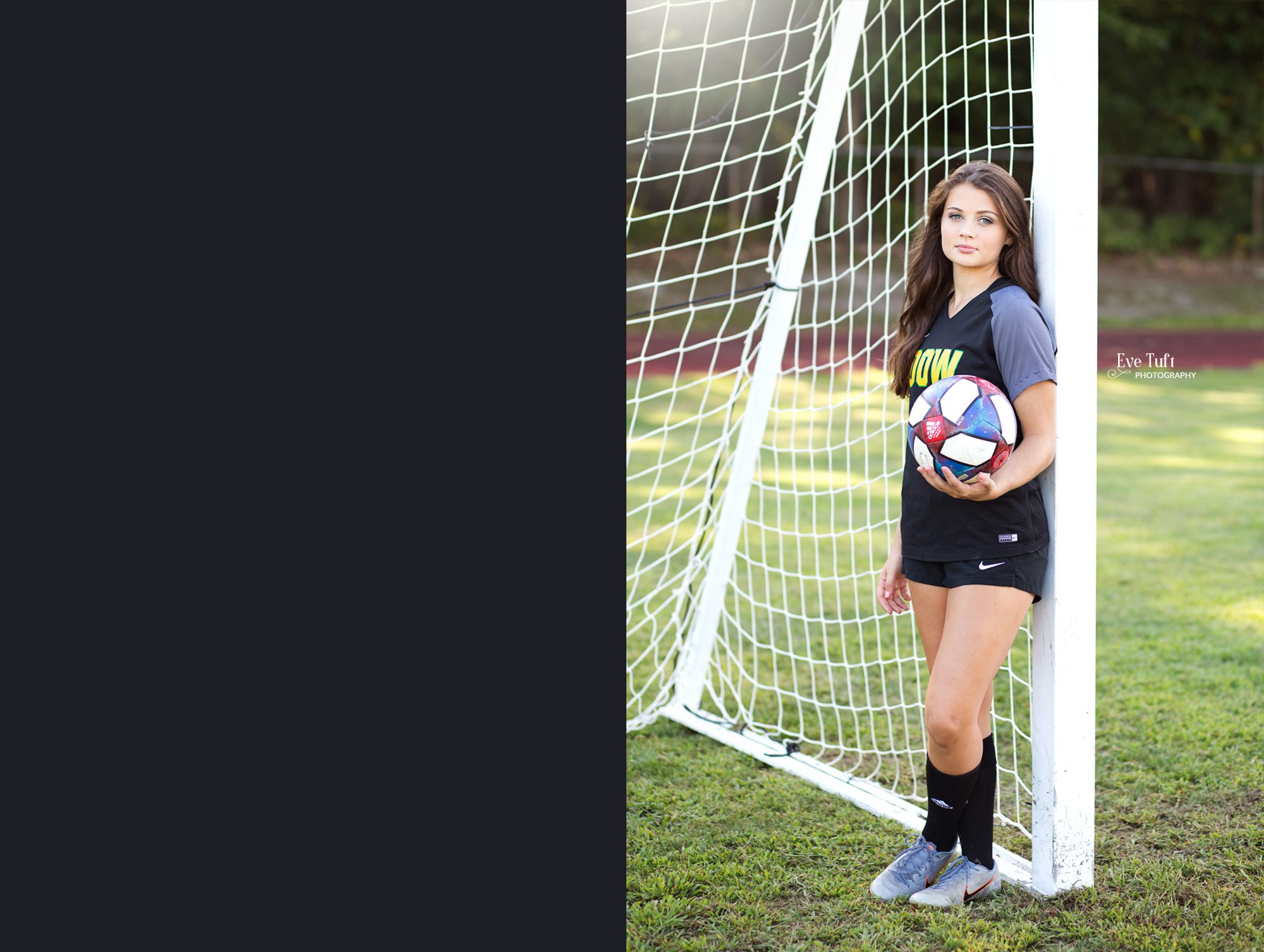 A senior girl stands against a soccer goal post holding a soccer ball for her senior pictures | Photographers in Midland, Michigan