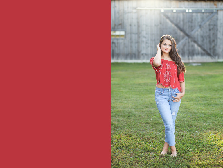 A senior girl stands in front of wooden barns | Michigan Senior Photographer