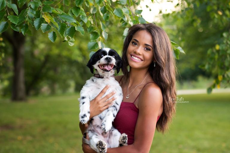 A beautiful teenager holds her dog near the Tridge in Midland, MI | Senior Photographers near me