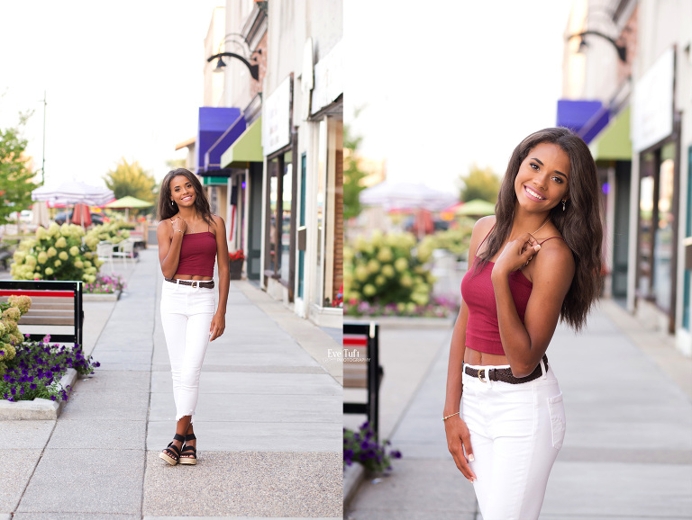 A senior girl poses on a sidewalk downtown in an urban location | Midland, MI senior photographer