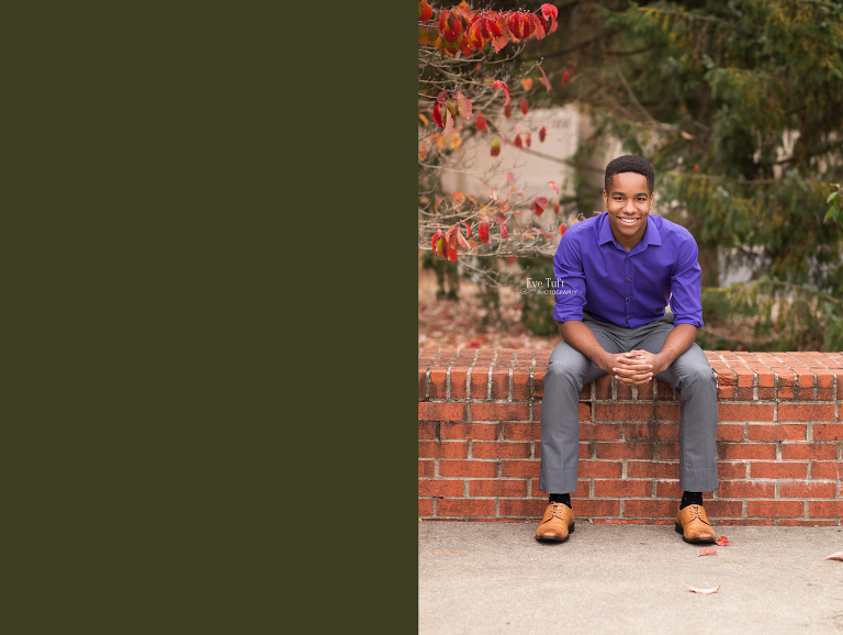 Senior guy sits on a brick wall outside for his senior pictures | Teen Photographer in Midland, Michigan