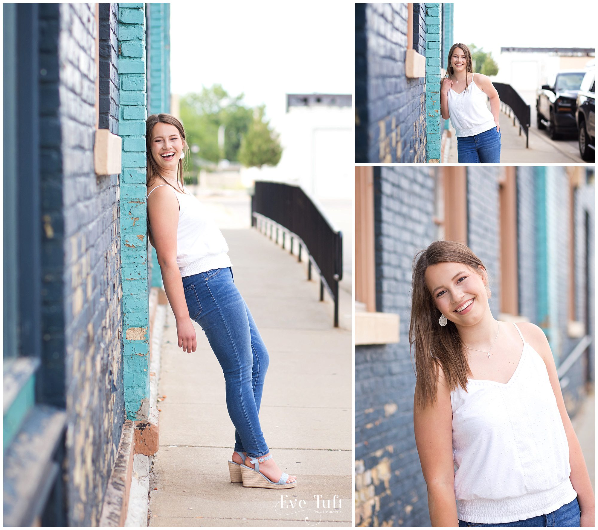 A senior girl laughs and leans against a blue brick wall in Bay City | Senior Photographers in Midland, Michigan