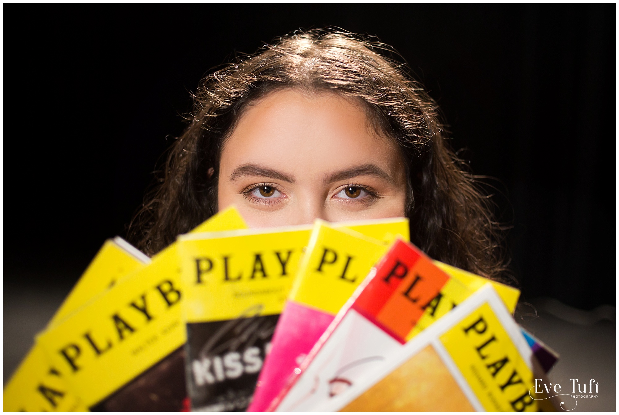 A senior girl holds up her playbills on stage | Midland, MI Senior Photoraphers