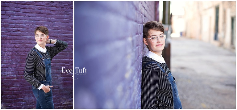 Beautiful teenager leans against a purple wall for her urban session in Downtown Bay City | Senior Photographer